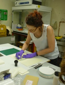 Icon Intern, Marta, cleaning glass before conservation.